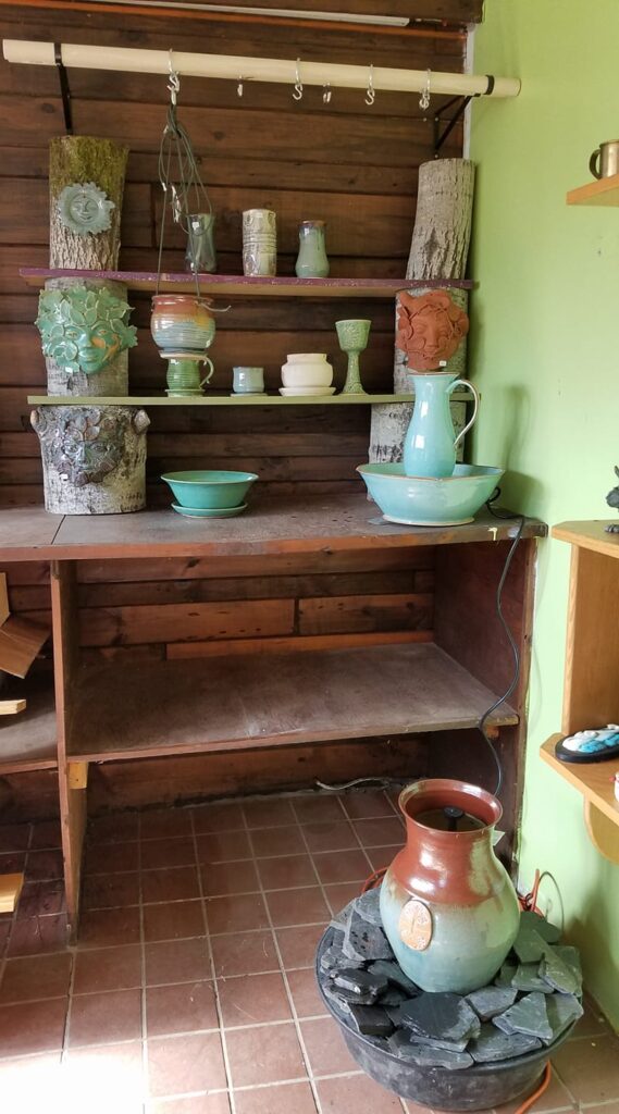 Pieces of handmade pottery on a shelf.