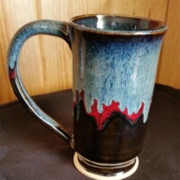 A blue, red and brown ceramic coffee mug.